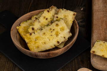 ripe pineapple of yellow-orange color cut into pieces