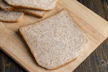 Square loaf of light wheat bread cut into pieces