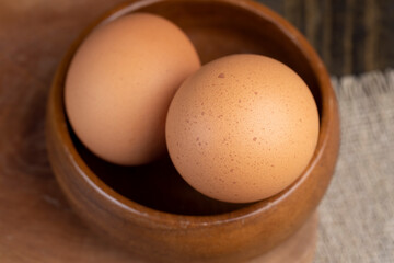 A whole orange chicken egg close-up on the table