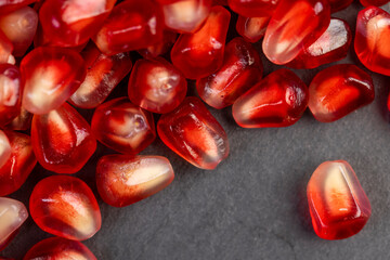 Peeled red pomegranate with ripe grains