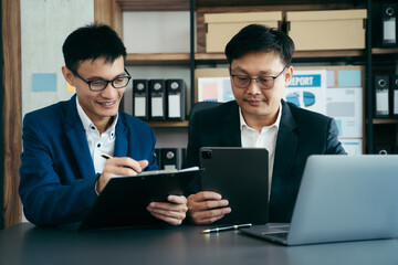 Businessmen team or financial data analysts working with tablets and laptop computers and data graphs together. Plan to analyzing projects in the office.