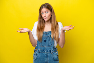 Young caucasian woman isolated on yellow background having doubts while raising hands