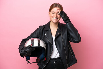 Young caucasian woman with a motorcycle helmet isolated on pink background has realized something and intending the solution