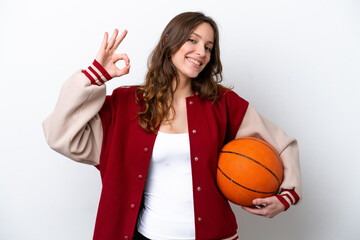 Young caucasian woman playing basketball isolated on white background showing ok sign with fingers