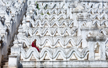 Mingun, Mandalay,Myanmar, November 16, 2021: Monks standing in temple Myanmar