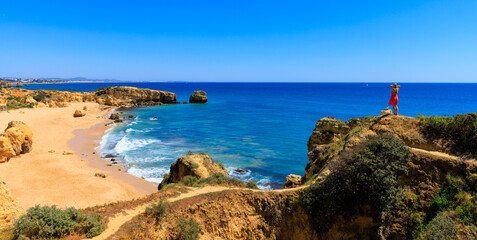 Woman tourist enjoying panoramic view of beautiful algarve beach- travel destination, summer...
