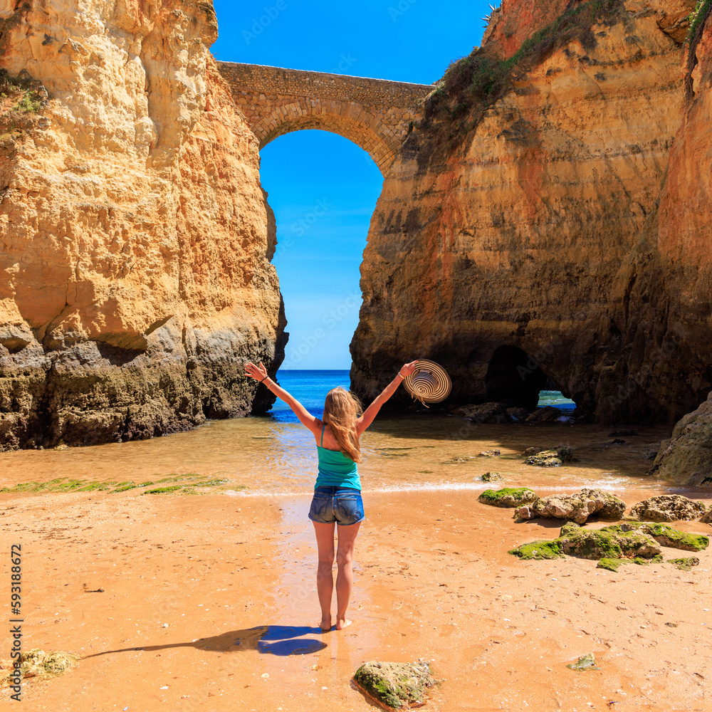 Wall mural tour tourism in Algarve- Ponte Romana de Lagos- Happy woman traveling in Portugal