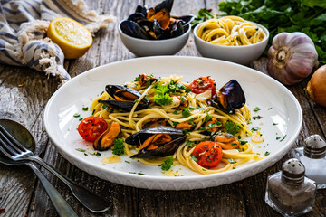 Noodles with clams on wooden table
