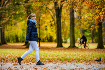 Beautiful woman walking in city park

