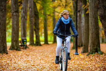 Woman riding bicycle in city park
