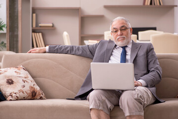 Old male employee working from home during pandemic