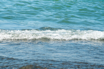Fototapeta na wymiar sea surf on the pebbles close-up relax