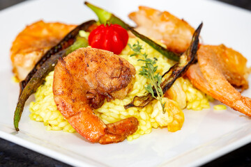 Shrimp risotto finely decorated with Pitanga fruit (Eugenia uniflora).