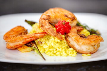 Shrimp risotto finely decorated with Pitanga fruit (Eugenia uniflora).