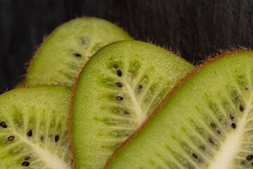 Ripe green kiwi sliced into thin slices