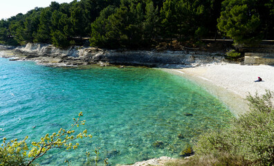 Sea lagoon with turquoise sea water and white pebble beach