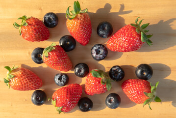 Fototapeta na wymiar strawberries and raspberry on the table
