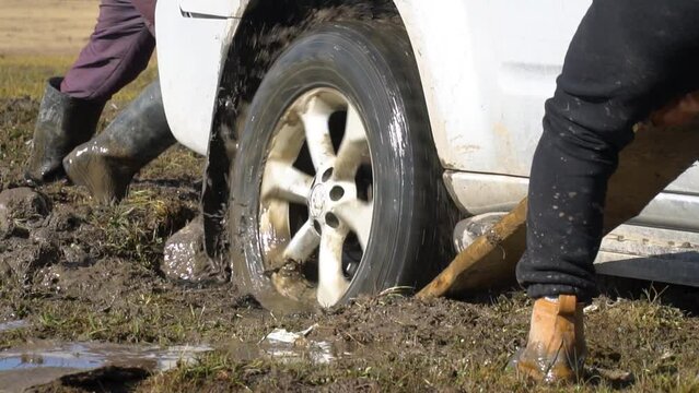 Slow motion view of stuck car in mud
