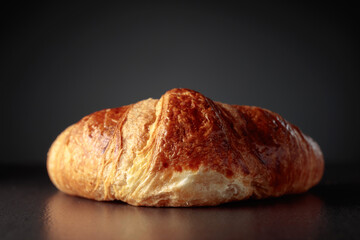 Croissant on a black ceramic table. Traditional French kitchen.