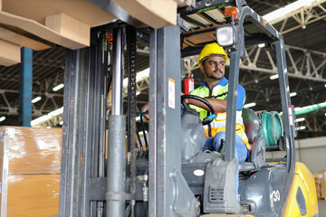 Warehouse workers or forklift driver man with hardhats and reflective jackets in vehicle using walkie talkie radio controlling stock and inventory in retail warehouse logistics, distribution center