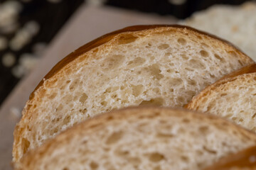 Wheat baguette on a wooden cutting board