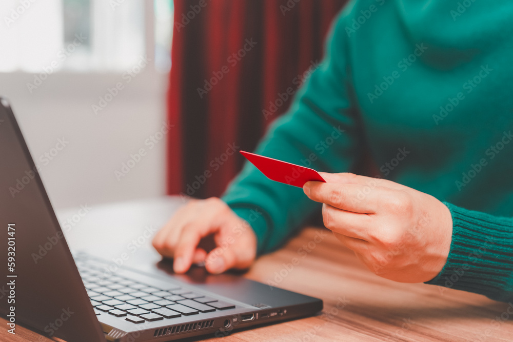 Poster young man using laptop to register via credit card to shop online. credit card secure online shoppin