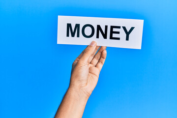 Hand of caucasian man holding paper with money word over isolated blue background