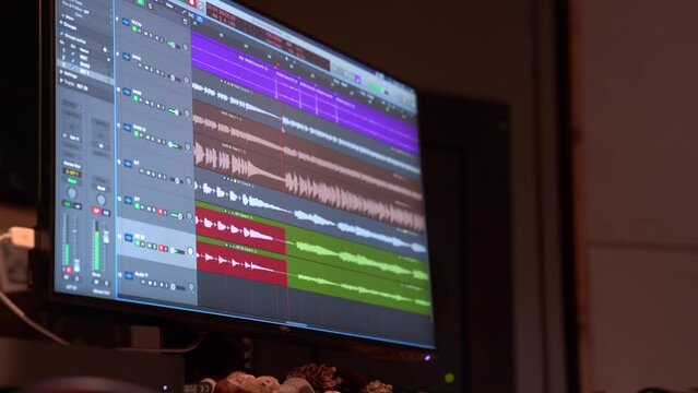 Sound mixing channels visible in monitor in recording studio during recording song close up