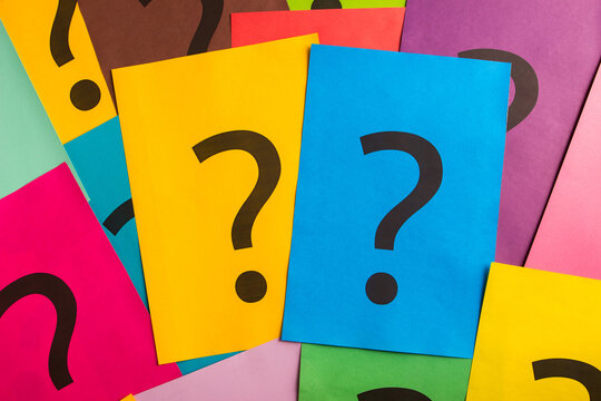 Black question marks on the colored papers - Powered by Adobe
