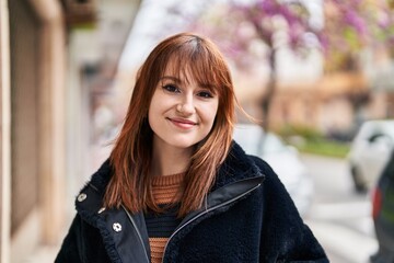 Young woman smiling confident standing at street