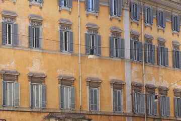 Typical Building Facade with Windows and Grey Shutters in Rome, Italy