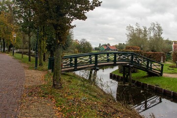 Fototapeta na wymiar Bridge over the river in the Zaanse Schans, Zaanstad, Netherlands.