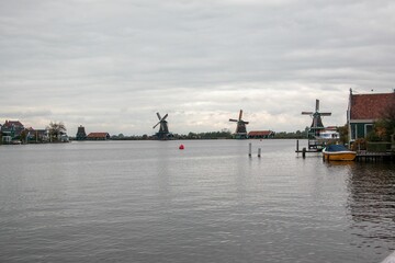 Windmills and wooden houses in the Zaanse Schans, Zaanstad, Netherlands.