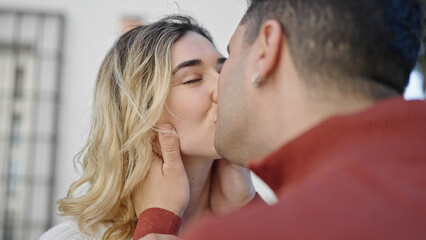 Man and woman couple kissing at street