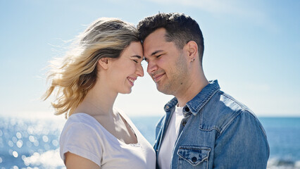 Man and woman couple smiling confident standing together at seaside