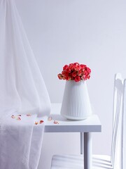 Beautiful view of a pink rose bouquet in a white vase on a minimalistic white table