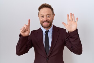 Middle age business man with beard wearing suit and tie showing and pointing up with fingers number six while smiling confident and happy.