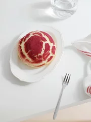 Fotobehang Vertical shot of a red crinkle cookie with crackles on a plate © Jingluo/Wirestock Creators