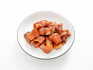 Close-up shot of stewed pork belly in a bowl on white background