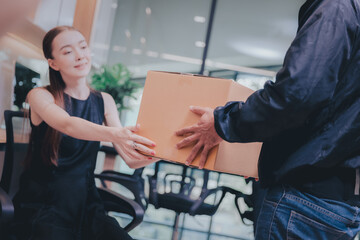 Forwarder goods delivery or shipping concept,Female customer receive delivering cardboard box from courier at office or home