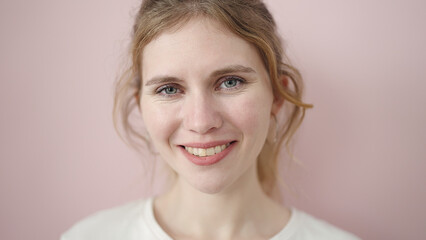 Young blonde woman smiling confident standing over isolated pink background