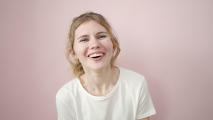 Young blonde woman smiling confident standing over isolated pink background