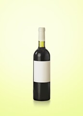 Red wine in glass bottle on pastel background.