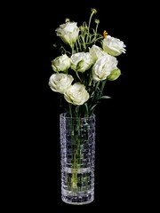 Vertical shot of a bouquet of white roses in a vase isolated on a dark background