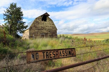 Old barn in Eastern Washington behind a rusty 