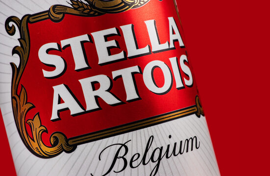 Ukraine. Dnipro. 20 march 2023: Can of Stella Artois beer on beer barrel with red background.