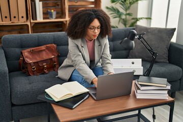 Young african american woman psychologist using laptop at psychology center