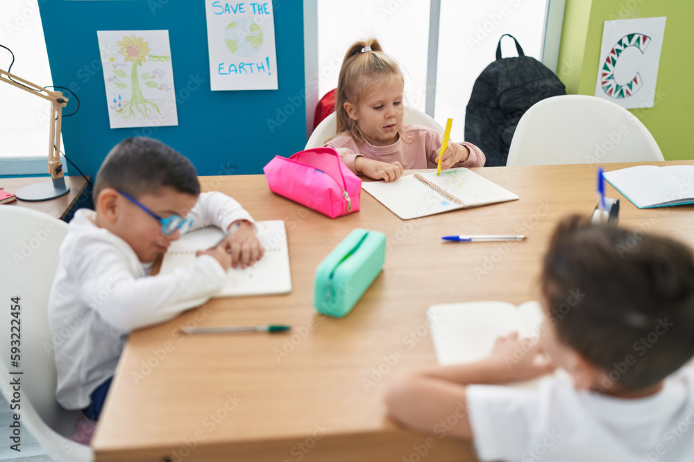 Poster group of kids students sitting on table drawing on notebook at classroom