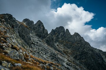 Beautiful landscape of big mountains with rocky peaks under the cloudy sky