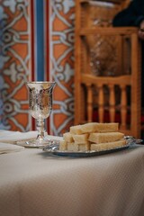 Vertical shot of a goblet and loaves of bread put on the table at a church for christian rituals